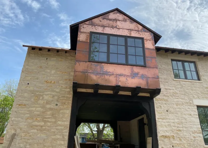 Copper metal panel facade on a stone building for Roof Repair in Bernalillo